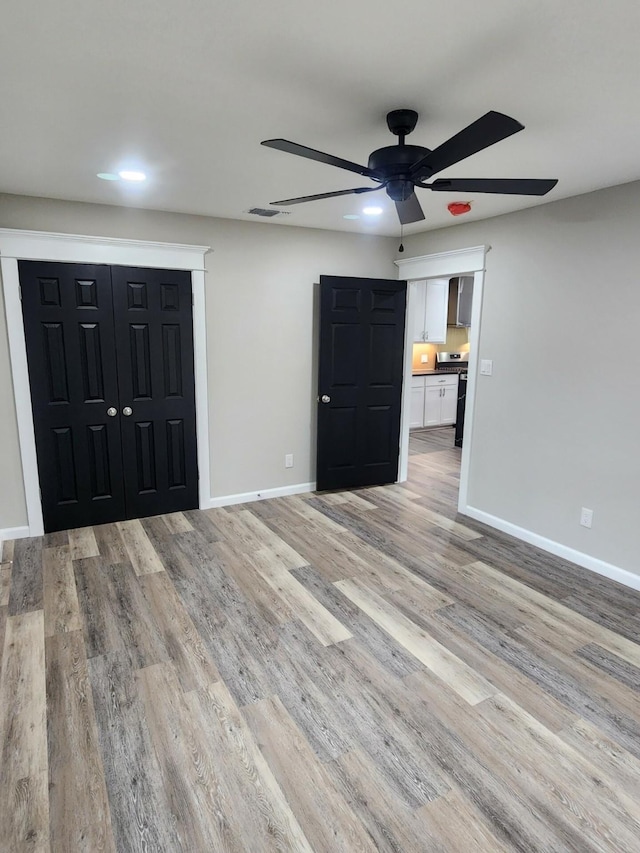 interior space featuring light hardwood / wood-style floors and ceiling fan