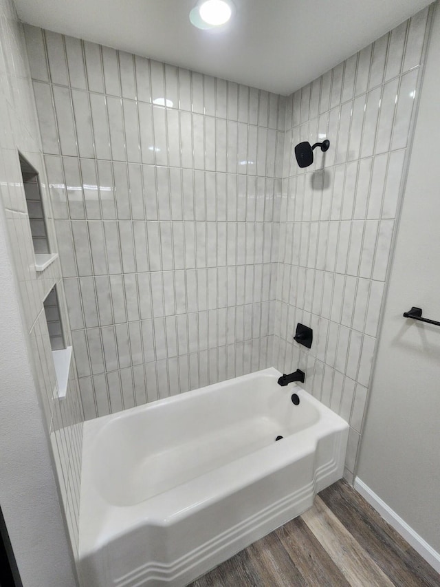 bathroom with wood-type flooring and tiled shower / bath combo