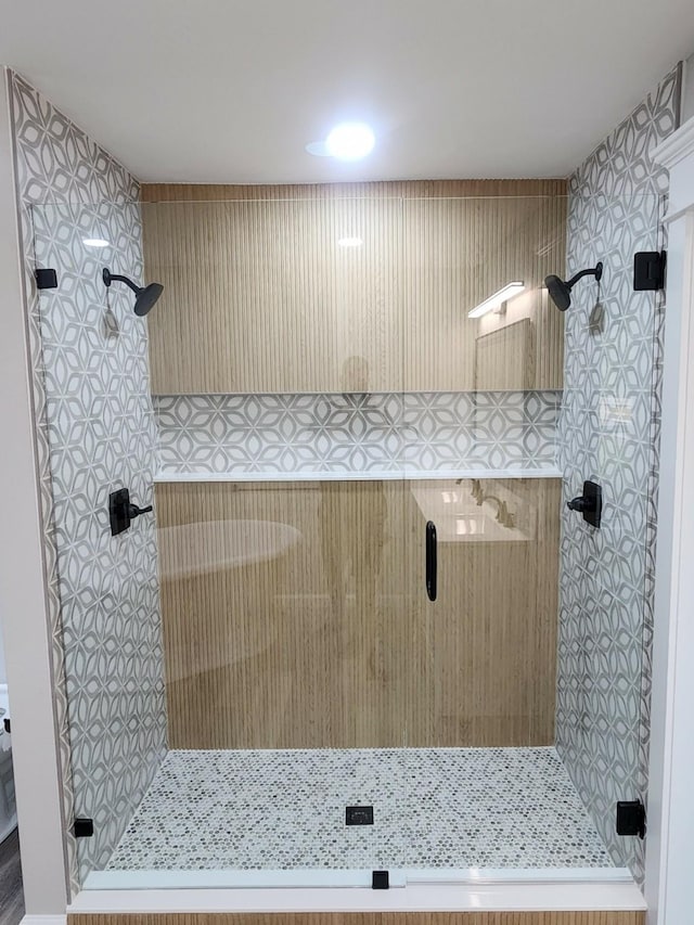 bathroom with a shower with door