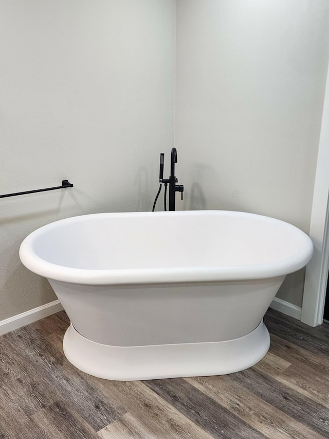 bathroom featuring hardwood / wood-style floors and a bathing tub