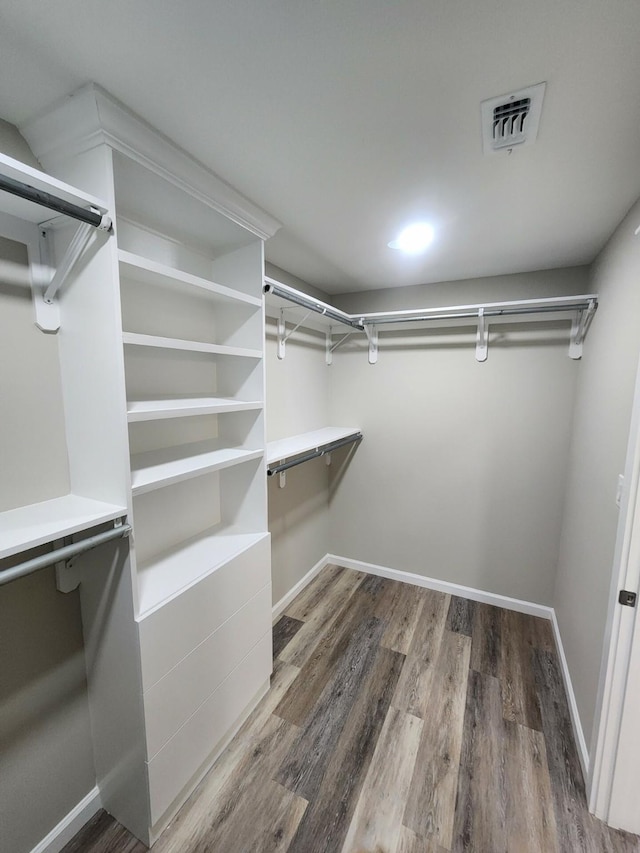 walk in closet featuring hardwood / wood-style flooring