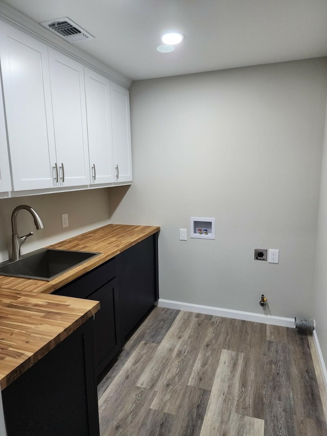 laundry area featuring cabinets, washer hookup, gas dryer hookup, electric dryer hookup, and sink