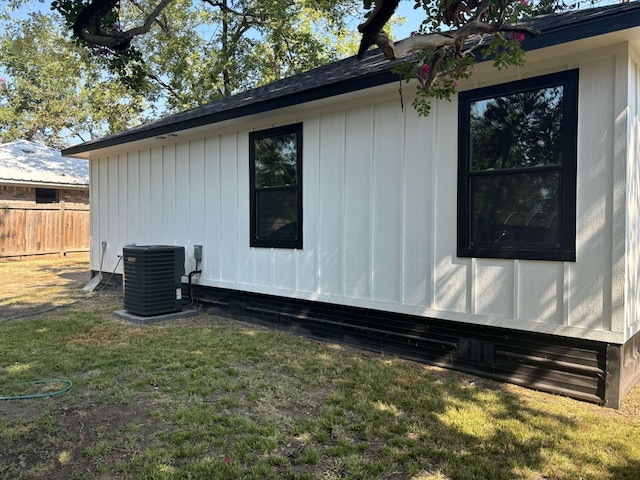 view of home's exterior featuring cooling unit and a lawn