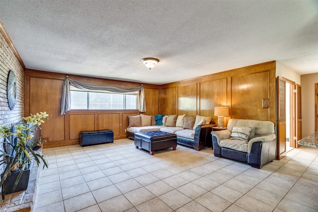 living room featuring wood walls, light tile patterned flooring, and a textured ceiling