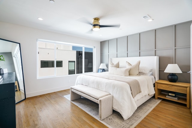 bedroom with ceiling fan and light hardwood / wood-style flooring