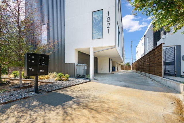 view of property exterior featuring a mail area