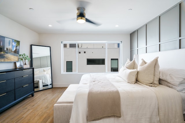 bedroom with light wood-type flooring and ceiling fan