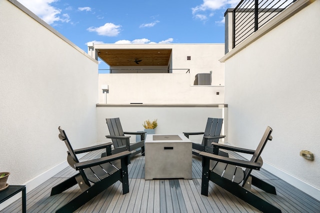 wooden deck with a fire pit