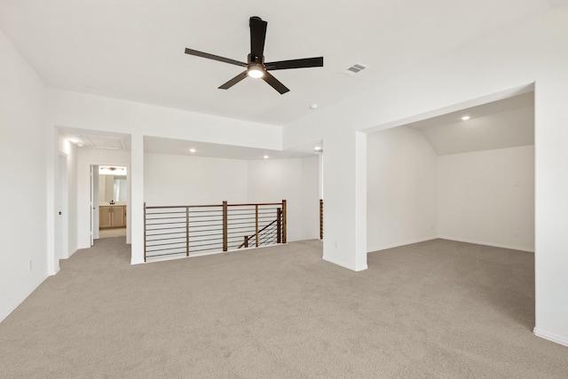 carpeted spare room featuring visible vents, ceiling fan, attic access, and recessed lighting