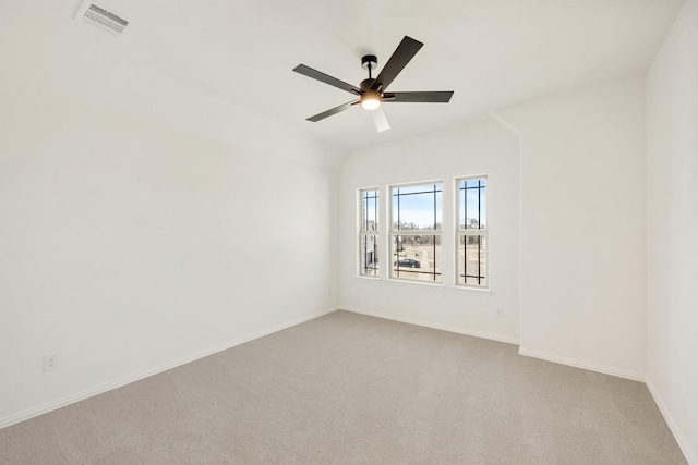 empty room featuring baseboards, visible vents, ceiling fan, and light colored carpet