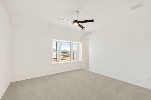 empty room with carpet, visible vents, ceiling fan, and baseboards