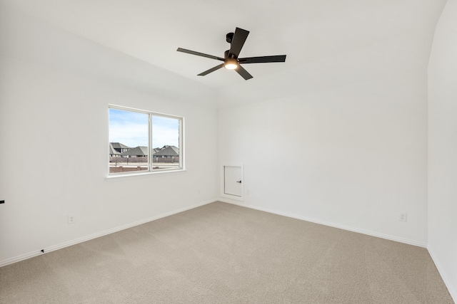 unfurnished room featuring a ceiling fan, light colored carpet, and baseboards