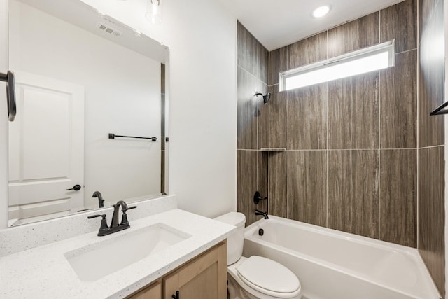 full bath with visible vents, vanity, bathtub / shower combination, and toilet