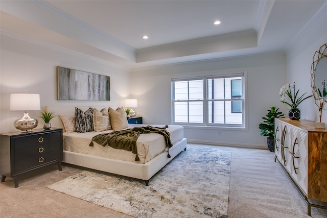 carpeted bedroom with ornamental molding and a raised ceiling