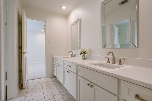 bathroom featuring vanity, tile patterned flooring, and crown molding