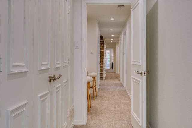 hallway with light carpet