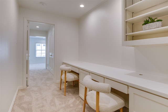 office space featuring light carpet and built in desk