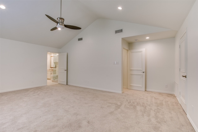 unfurnished bedroom featuring lofted ceiling, light colored carpet, ceiling fan, and ensuite bath