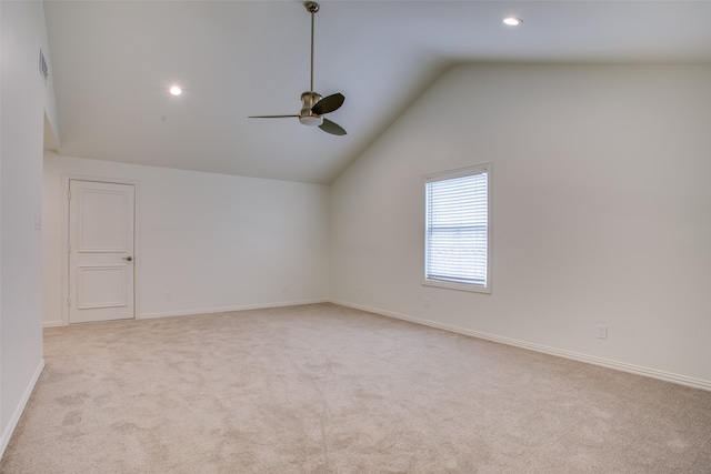 carpeted empty room featuring ceiling fan and vaulted ceiling