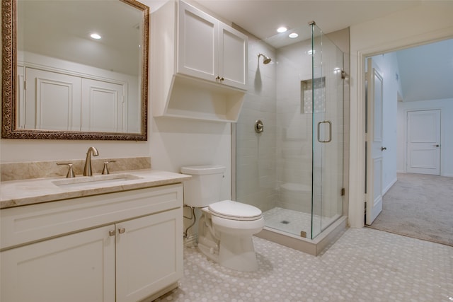 bathroom with tile patterned flooring, vanity, toilet, and a shower with door