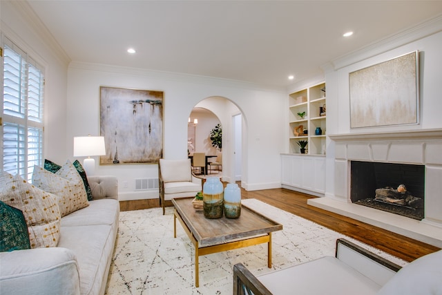 living room with light hardwood / wood-style flooring and ornamental molding