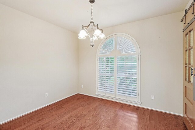 dining room featuring wood-type flooring and a barn door