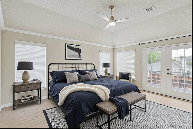 bedroom featuring visible vents, light wood-style flooring, access to exterior, crown molding, and french doors