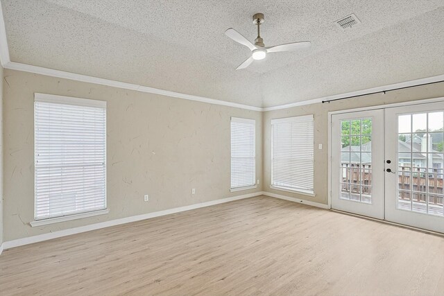 bedroom with french doors, crown molding, a textured ceiling, access to exterior, and light hardwood / wood-style floors