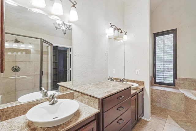 full bath featuring a garden tub, two vanities, a sink, and a shower stall