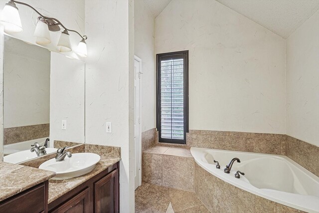 bathroom featuring tile patterned flooring, vanity, and shower with separate bathtub