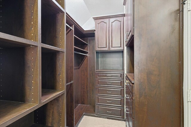 bathroom with vanity, a shower with door, french doors, and lofted ceiling