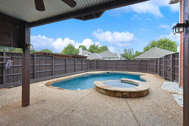 view of pool featuring a patio area, a fenced backyard, a pool with connected hot tub, and ceiling fan