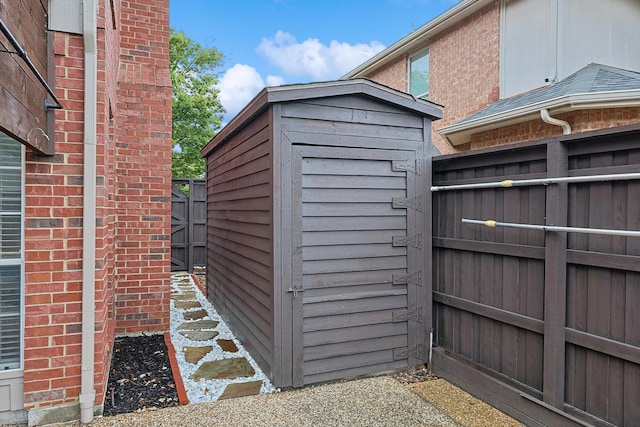 view of shed featuring fence