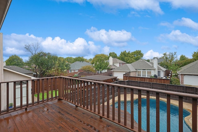 wooden terrace with a fenced in pool