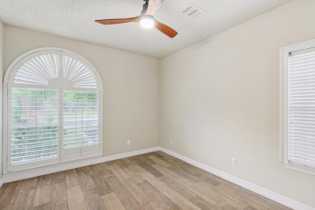 office area with ceiling fan, light hardwood / wood-style flooring, and a textured ceiling