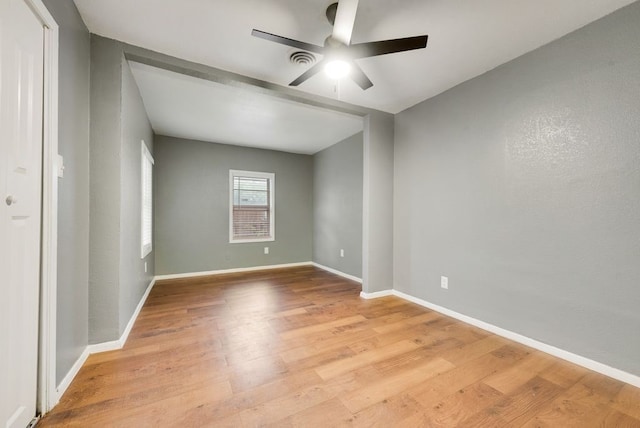 empty room with light hardwood / wood-style floors and ceiling fan