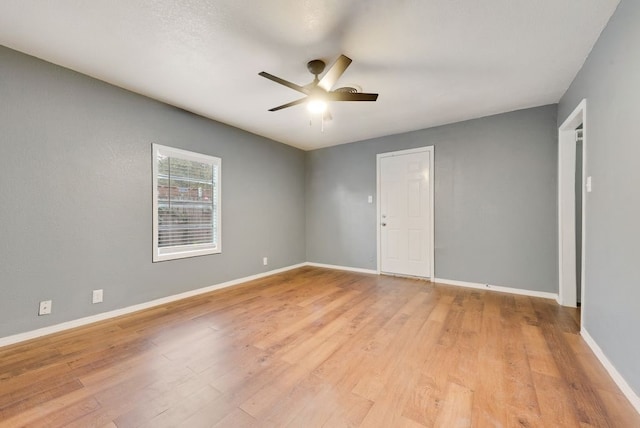 empty room featuring ceiling fan and light hardwood / wood-style floors