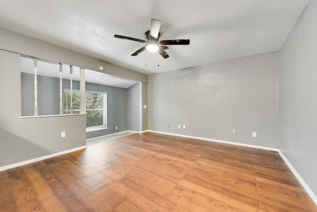 spare room with ceiling fan, wood-type flooring, and a textured ceiling