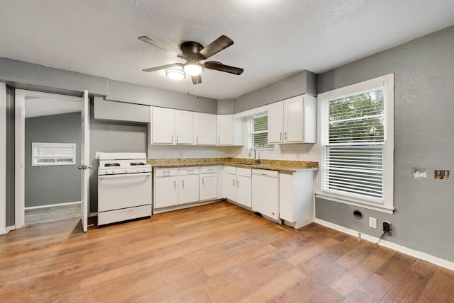 kitchen with white cabinets, sink, ceiling fan, light hardwood / wood-style flooring, and white appliances