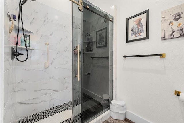 bathroom featuring hardwood / wood-style flooring and a shower with door