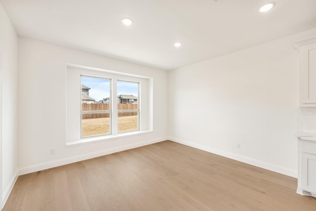 unfurnished room featuring recessed lighting, baseboards, and light wood finished floors