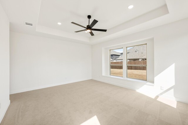 bedroom featuring multiple windows, light colored carpet, and ceiling fan