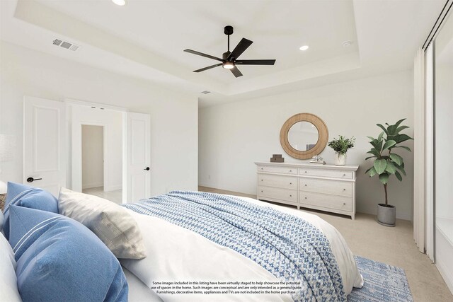 bedroom featuring carpet, ceiling fan, and a raised ceiling