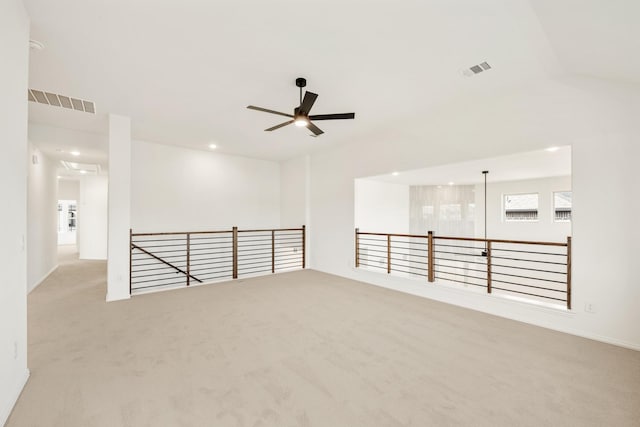 spare room with ceiling fan, carpet flooring, and visible vents