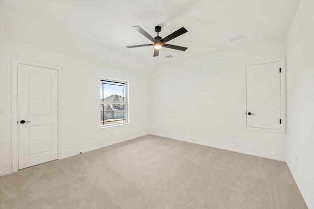 unfurnished room with light carpet, ceiling fan, visible vents, and lofted ceiling