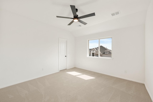 unfurnished room featuring carpet floors, ceiling fan, visible vents, and lofted ceiling