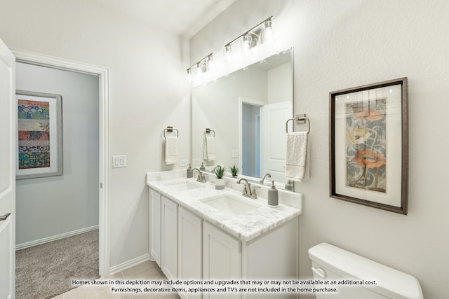 bathroom featuring toilet, vanity, and tile patterned flooring