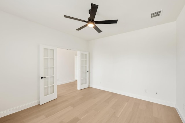 unfurnished room with french doors, visible vents, light wood-style flooring, and baseboards