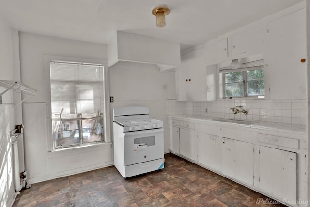 kitchen with backsplash, white range, sink, tile counters, and white cabinets