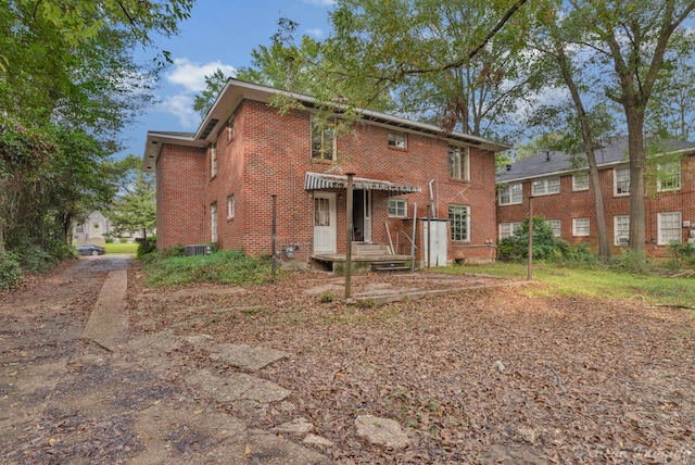 back of house with central AC unit